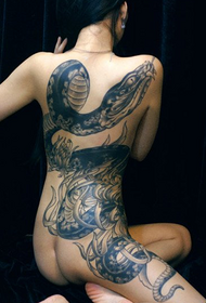 Female back snake tattoo