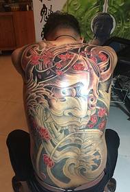 Full-back big prajna tattoo pattern confidently blooms