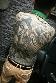 A full back tattoo with a combination of Buddha and squid