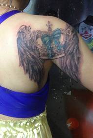 female arm beautiful crown wing tattoo