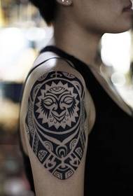 female creative totem arm tattoo