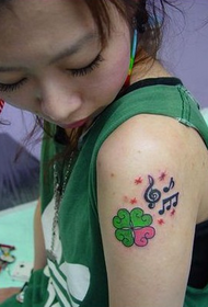 arm four-leaf clover tattoo