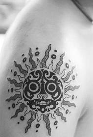 domineering and stylish black and white sun god tattoo