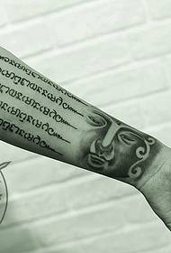 arm Buddha head scripture tattoo