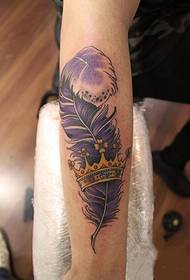 purple feather crown arm tattoo