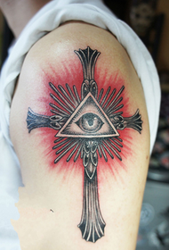 arm cross and God's eye tattoo