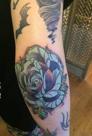 beautiful blue rose tattoo on the arm