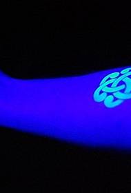 shiny fluorescent tattoo on the arm