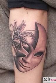 gorgeous and mysterious mask tattoo on the arm