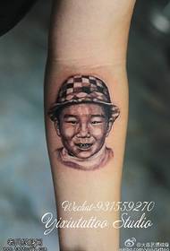 Realistic portrait of a son's portrait tattoo