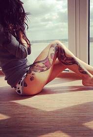 Graži tatuiruotė figūra ant gražios moters kojų