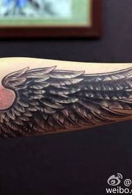 Arm wing prick tattoo pattern