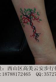 Green small tree arm tattoo
