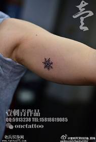 Snowflake tattoo pattern on arm