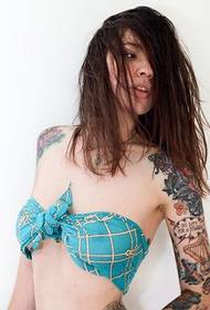 Sexy tattooed woman wearing a bikini