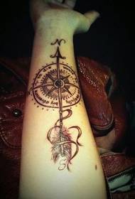 Красиво выглядящая татуировка компаса на руке девушки