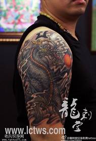 Arm domineering dragon tattoo pattern