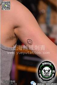Smiley tattoo on the arm