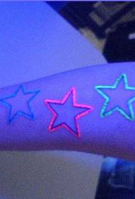 Glittering fluorescent tattoo on the arm
