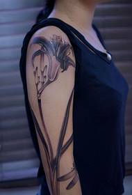 Blooming lily flower arm tattoo picture