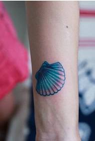 Girl's arm only beautiful looking small shell tattoo picture