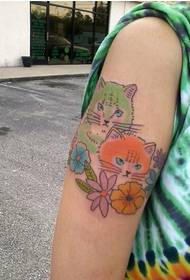 Girl's arm can be seen with a stunned cat tattoo pattern picture