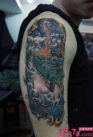 I-Domineering whale sailing arm tattoo isithombe