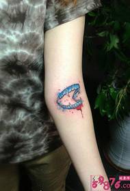 Creative blood drop tooth arm tattoo picture