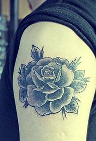 Black and white rose arm tattoo