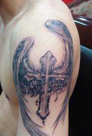 Arm with a winged cross tattoo