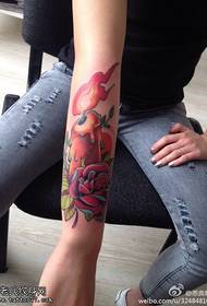 Female arm color candle rose tattoo pattern