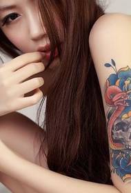 Beautiful girl has a beautiful tattoo on her arm to enjoy the picture
