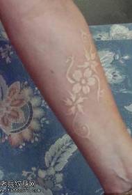Female arm invisible white flower tattoo pattern