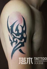 Men's arm totem tattoo