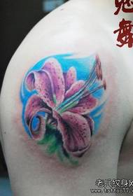 A gorgeous colorful lily tattoo pattern on the arm