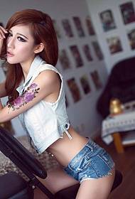 Beautiful woman tempting photo picture with big flower tattoo on arm