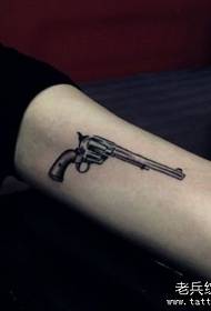 Girl arm a small pistol tattoo pattern