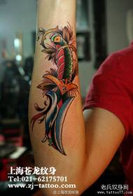 Girl's arm, a dagger tattoo pattern