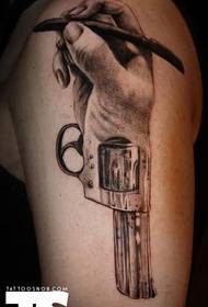 Arm with a creative hand and gun tattoo