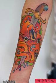 Arm color school style dagger octopus tattoo work