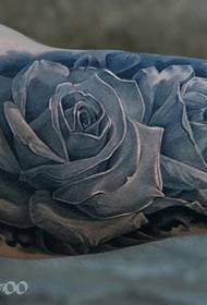 Classic European and American colored rose tattoo on the inside of the arm