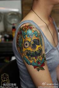 Female arm colored skull tattoo pattern