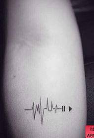a small arm with a fresh ECG tattoo pattern