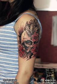 Female arm colored skull rose tattoo pattern