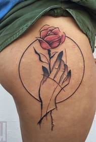 female side hip painting style hand holding rose tattoo picture