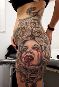 female waist and hip on the horror of Medusa tattoo