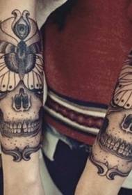 arm black skull with butterfly tattoo pattern