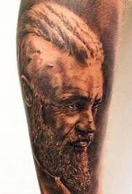 film star Ragnar Lothbrok portrait tattoo on the calf