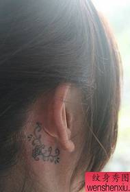 girl's ear delicate totem vine tattoo pattern