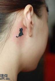 a small black cat tattoo pattern behind the ear